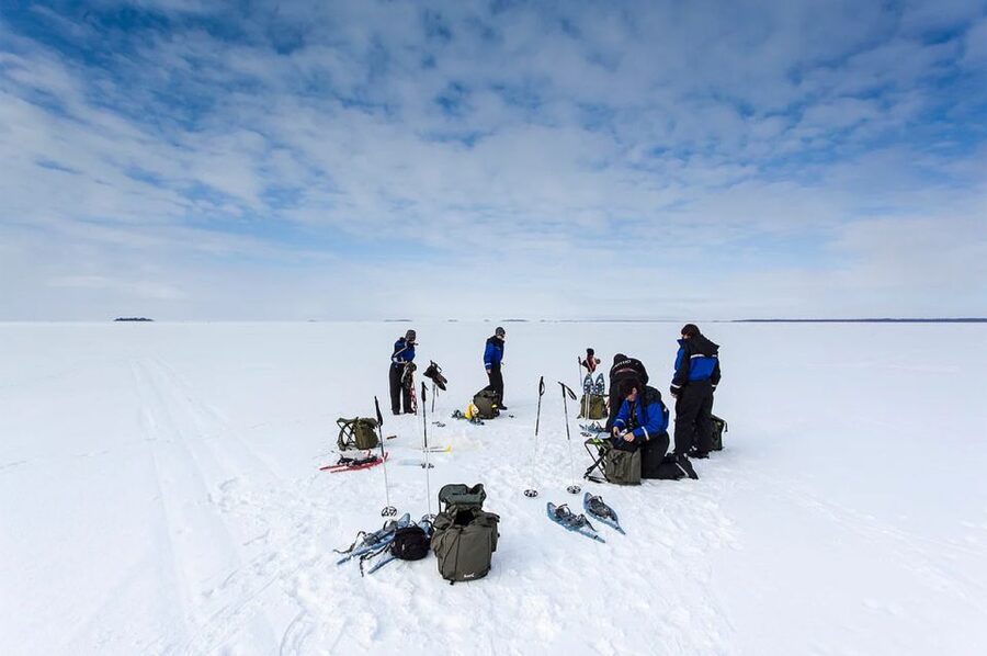 Lapland: Ice Fishing, Floating & BBQ Snow Adventure - Ice fishing lesson: making the hole and using the gear